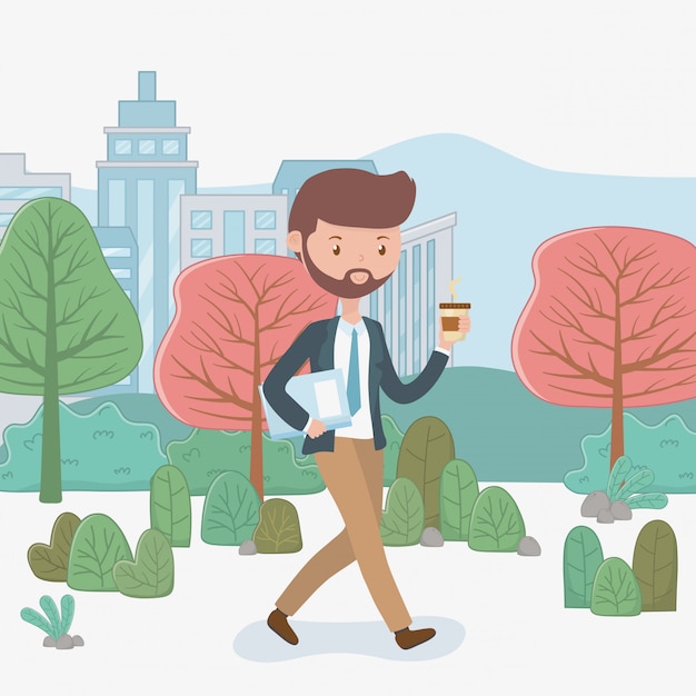 Young businessman with coffee walking in the park