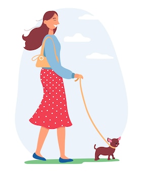 犬​と​一緒​に​歩いている​若い​女性​。