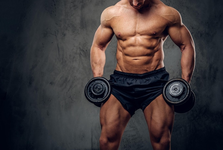 Gratis Foto attractive muscular bodybuilder is doing exercises with barbels and showing his muscules on the dark background.