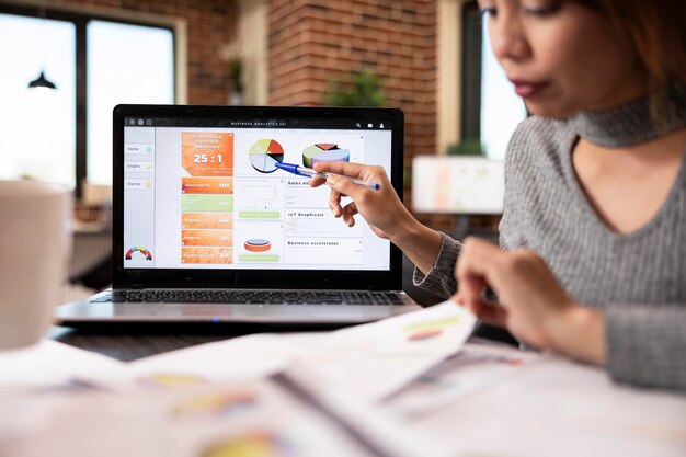 Office worker pointing at laptop screen