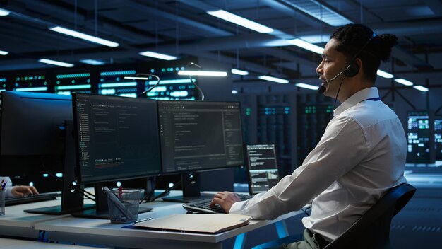 Server hub IT professional talking in microphone with system administrators