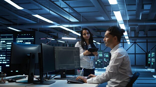Team of programmers in high tech data center troubleshooting issues