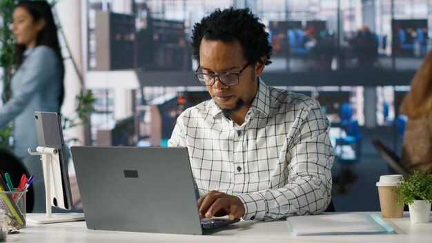 African american general manager reviews business forecasts and plans