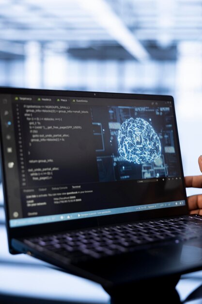 Computer scientist using laptop in data center updating AI