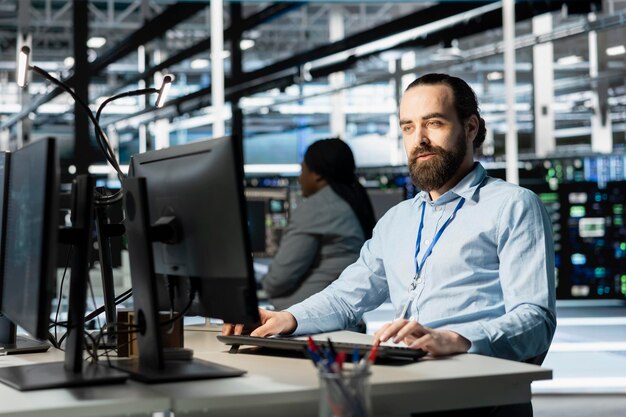 Data center programmer using PC to update servers tech configuring gear