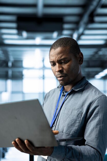 Engineer in data center using laptop adjusting power management settings