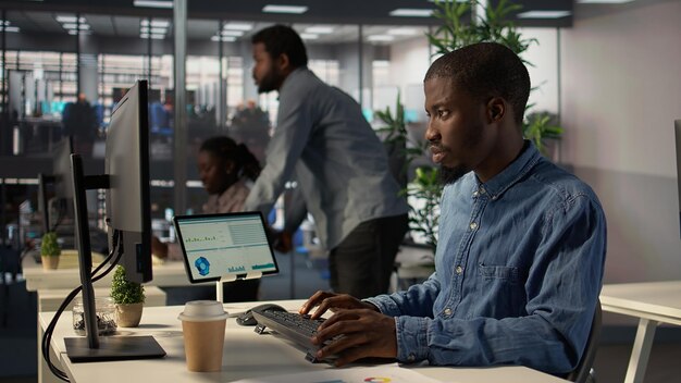 General director in modern office engaged in infographics reports
