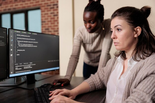 Informational agency multiracial tech engineers programming application while using computer. Cyber security company developers encrypting cloud processing data system using blockchain technology.
