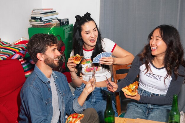 medium shot friends eating pizza