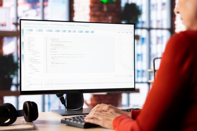 Person typing into an AI chatbot system to automate her workflow at home office