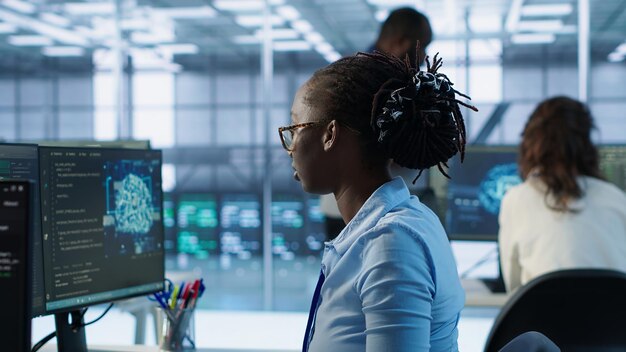 Portrait of happy computer scientist programming in AI data center