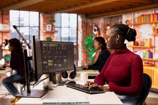 Programmer coding advanced AI algorithm in startup workspace