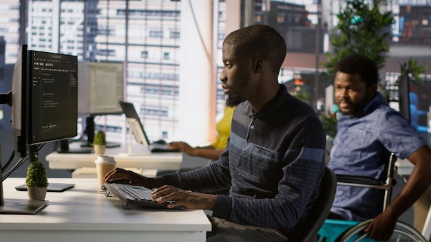 Programmer doing software debugging asking for help from smiling team leader