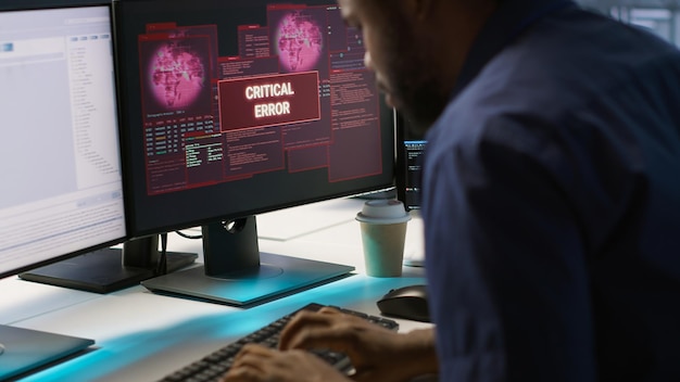 Programmer seeing error popup on computer display in data center