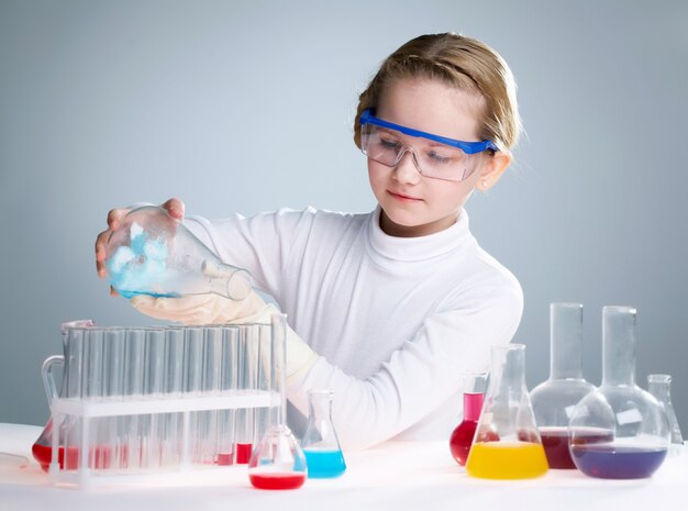 Schoolgirl using test tubes
