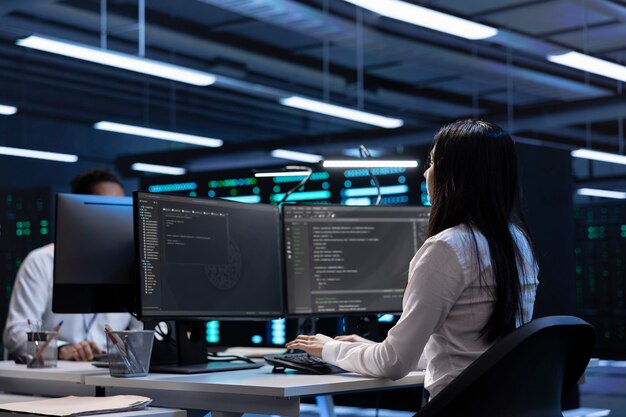Software developers in data center running system diagnostic tests on PC