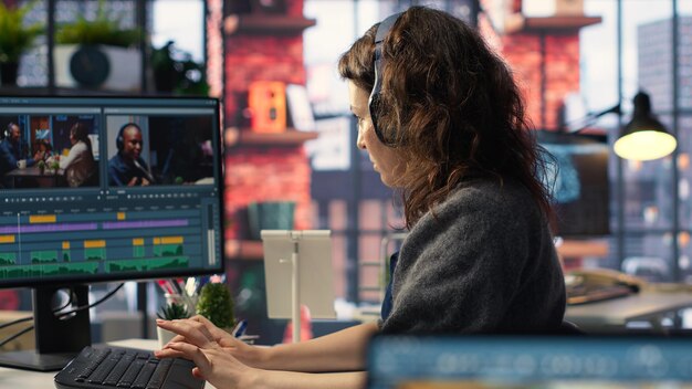 Video editor working on media post production from agency office
