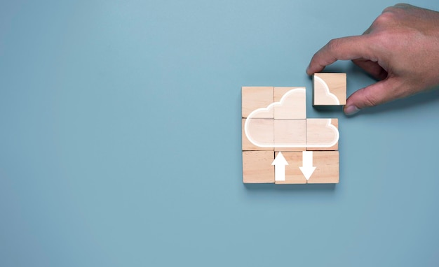 Ã Â¹ÂHand holding wooden cube block to assemble cloud computing , Cloud technology use for storage and sharing big data and information , Digital Technology transformation concept.