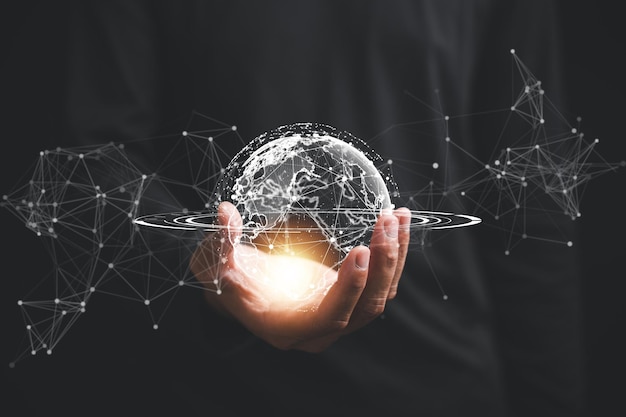 A businessman's hand holds a globe illustrating seamless connectivity and data flow across global network