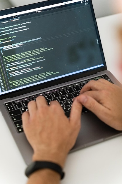 a cropped image of a young man working on a computer