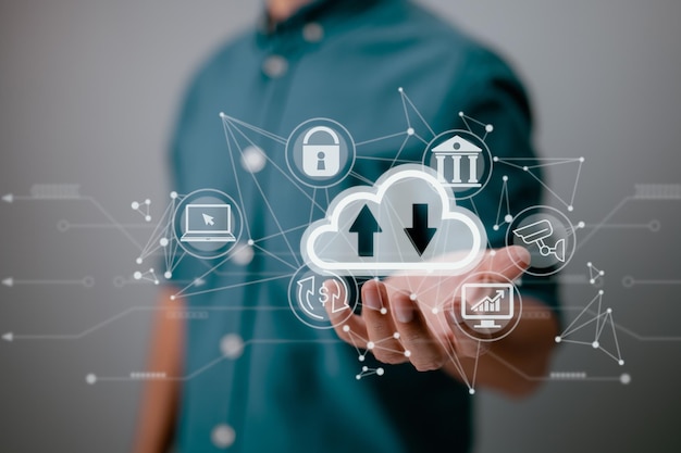 A man holding a cloud computing diagram displayed on the screen Concepts of cloud computing data storage networking and internet services