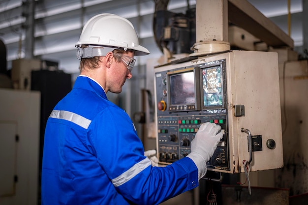 a man in a blue jacket is working on a machine