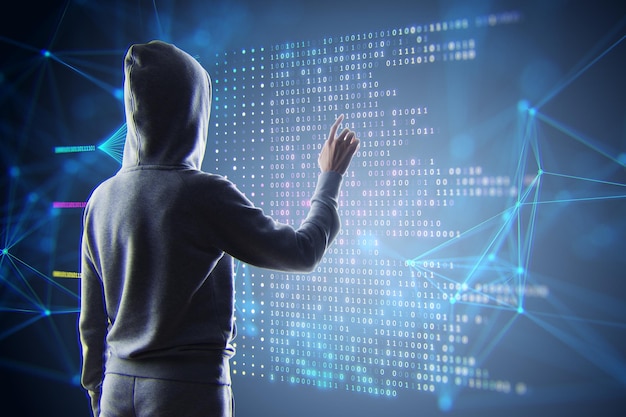 a person in a hoodie interacts with a futuristic interface depicting binary code on a dark background symbolizing big data and technology concepts