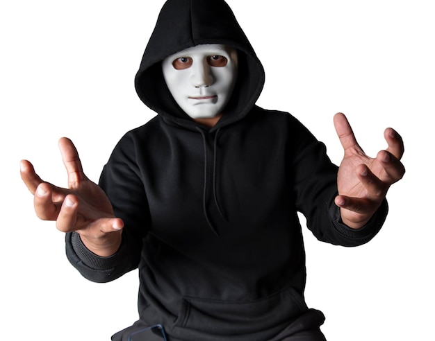 A portrait of an anonymous hacker wearing a mask and a black hoodie sitting with his head tilted and terrifying with clipping path Hacking and malware concept