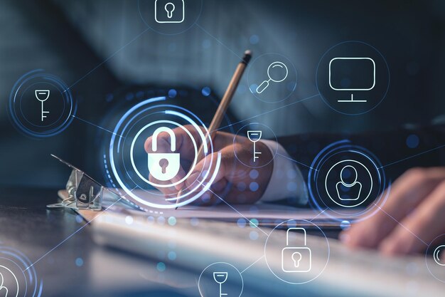 A programmer is taking notes of clients needs to protect cyber security from hacker attacks and save clients confidential data Padlock Hologram icons over the typing hands Formal wear