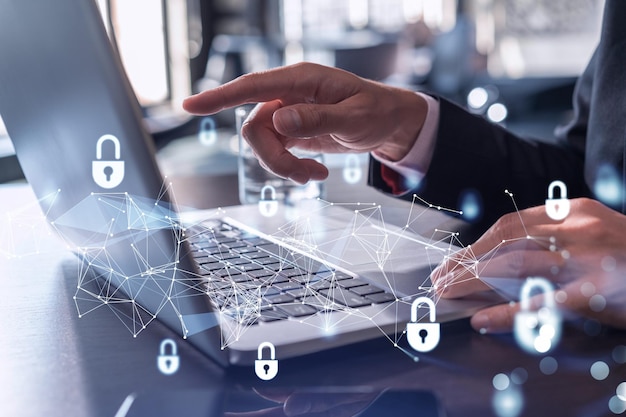 A programmer is typing a code on computer to protect a cyber security from hacker attacks and save clients confidential data Padlock Hologram icons over the typing hands Formal wear