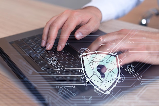 A programmer is typing a code on computer to protect a cyber security from hacker attacks and save clients confidential data Padlock Hologram icons over the typing hands Formal wear