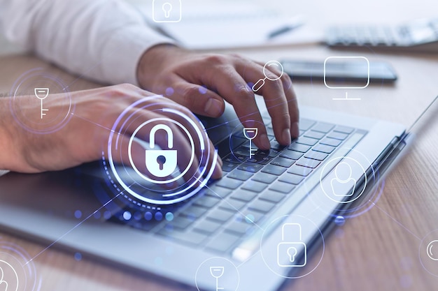 A programmer is typing a code on computer to protect a cyber security from hacker attacks and save clients confidential data Padlock Hologram icons over the typing hands Formal wear