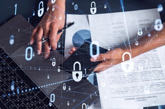 A woman programmer is typing a code on computer to protect a cyber security from hacker attacks and save clients confidential data Padlock Hologram icons over the typing hands Casual wear