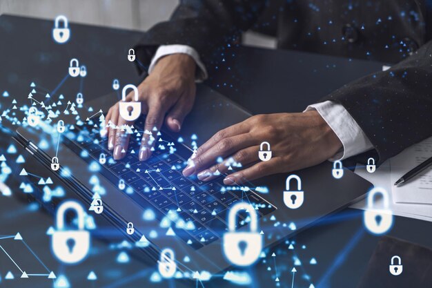 A woman programmer is typing a code on computer to protect a cyber security from hacker attacks and save clients confidential data Padlock Hologram icons over the typing hands Formal wear