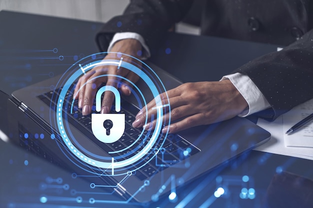 A woman programmer is typing a code on computer to protect a cyber security from hacker attacks and save clients confidential data Padlock Hologram icons over the typing hands Formal wear