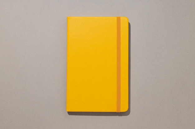 A yellow notebook lies on a light background