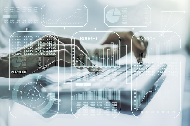 Abstract creative analytics data spreadsheet with hands typing on laptop on background analytics and analysis concept Multiexposure