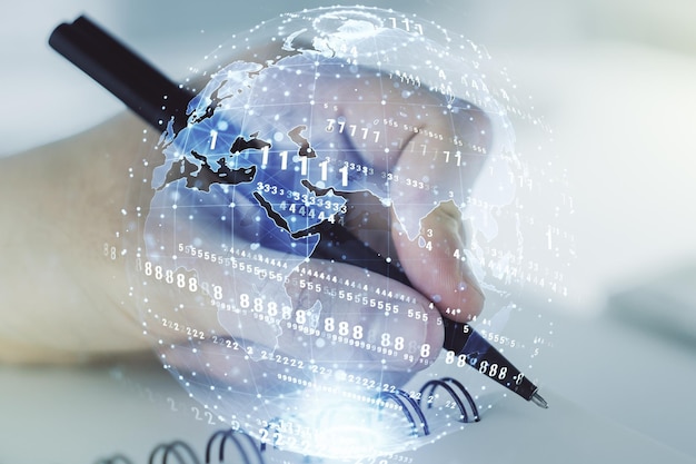 abstract creative coding concept with world map and man hand writing in notebook on background multiexposure