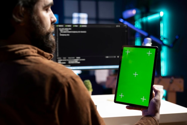 admin doing software debugging using green screen tablet checking code errors