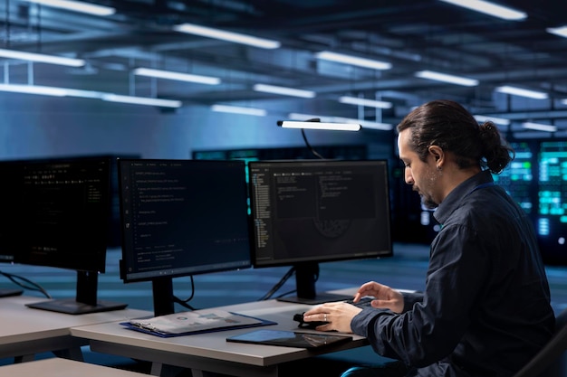 admin working on computer to check for signs of imminent failure in data center