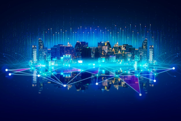 Aerial view of illuminated city against blue sky
