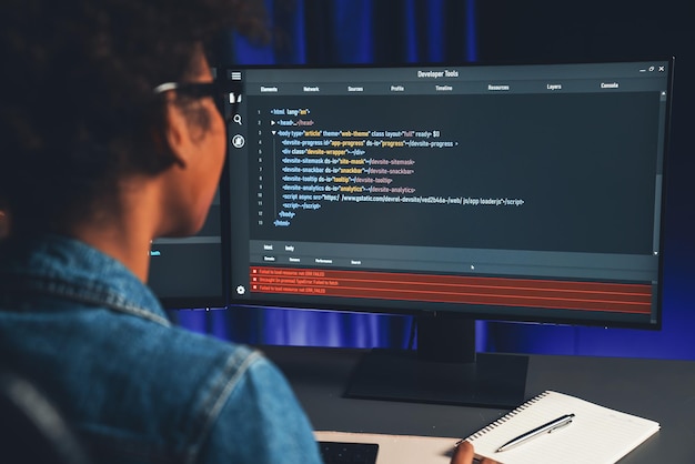 african it developer concentrating codding program on laptop screen tastemaker