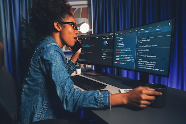 African IT developer concentrating codding program on laptop screen Tastemaker
