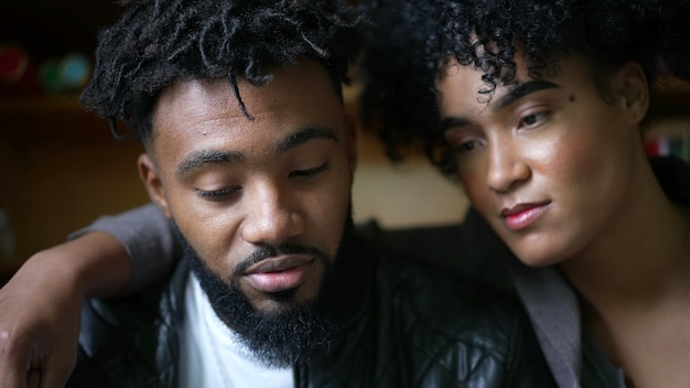an african couple faces hypnotized by online content