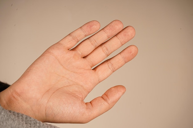 an open palm is extended forward creating a gesture that can signify welcome or a request to stop the neutral background highlights the simplicity of the action a clear and versatile expression