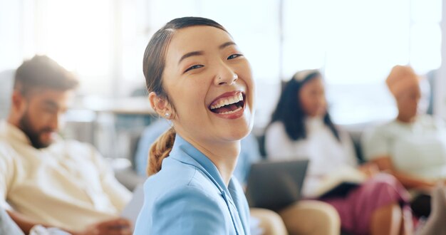 asian business woman face and coworking space with digital marketing team advertising people or branding men and women portrait smile and happy creative designer in modern office with innovation