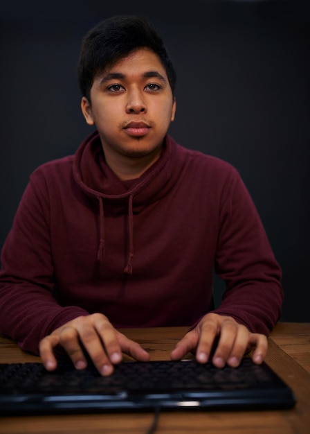 asian man face and keyboard for coding programmer and information technology with video game or software development internet computer programming with gamer or developer for cyber security
