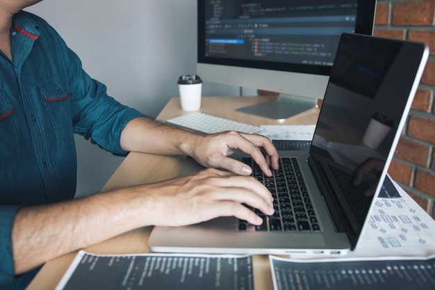 Asian man working code program developer computer web development working design software on desk in office