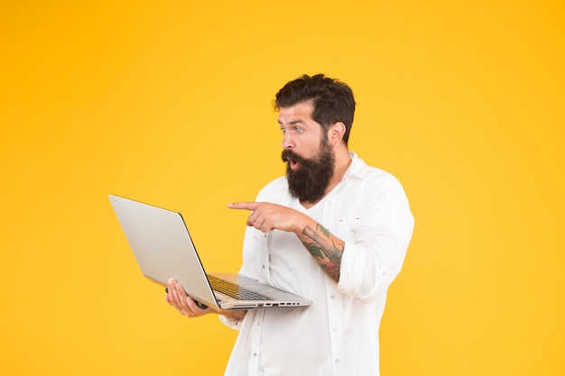 bearded man with notebook. online shopping. man using notebook. digital world. programming concept. programmer with laptop. surfing internet. in search of inspiration. online payment. online purchase.