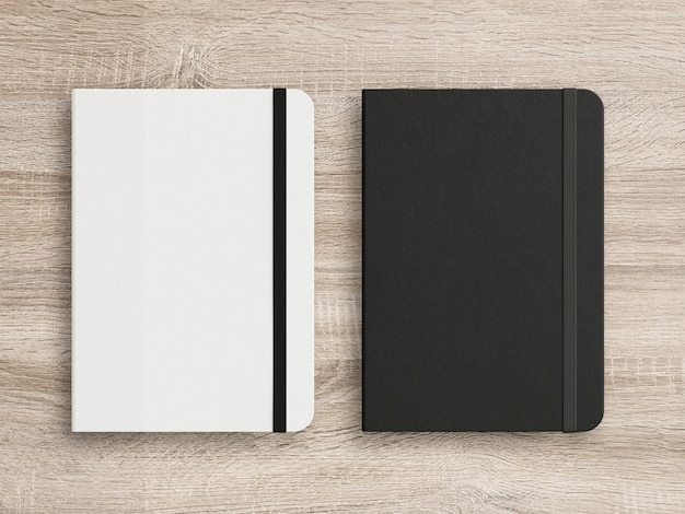 Black and White moleskine isolated on the wooden background